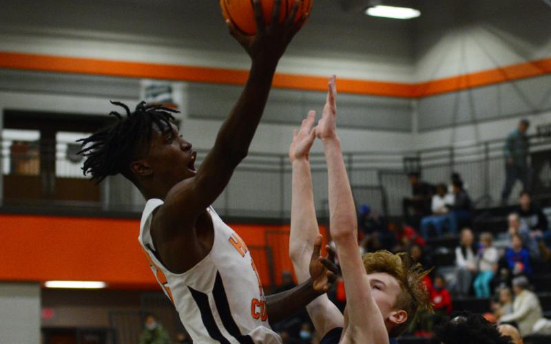 Terrance Mitchell makes a layup over the Eagle's defender.