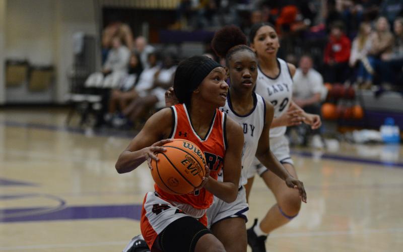 Valasha Carter drives into the paint against Monroe Area High School.