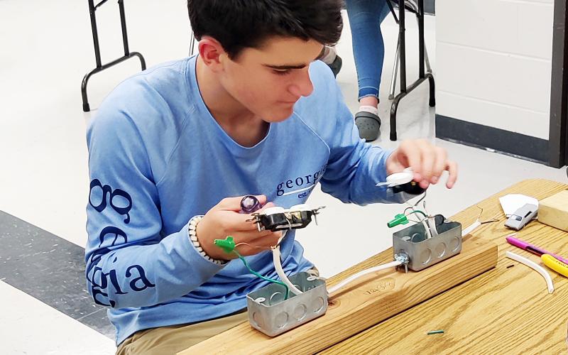 Photo submitted Hart County Middle School student Boston Graham wires an outlet circuit during an ag mechanics unit.