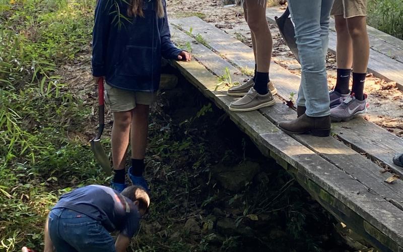 Photo submitted - HCHS student Conner Sasher, along with other classmates, digs  sand out of a creek to collect soil profiles for an agricultural class.