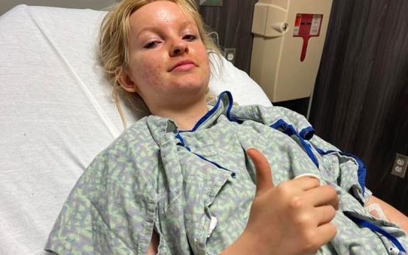 Kaylee Worley, 16, gives a thumbs up at Greenville Hospital hours after braving a racing accident at Lavonia Speedway on Saturday, Feb. 19.