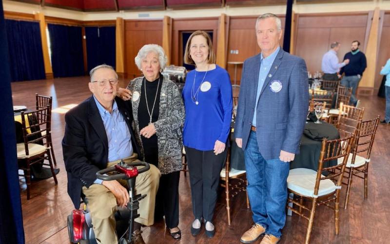 From left to right, Rotarian Joe Whittemore, Barbara Edmunds, Cathy Edmunds Redfern and Rotary president Rich Mewborn smile after celebrating a moment for their friend and family member Jack Edmunds.