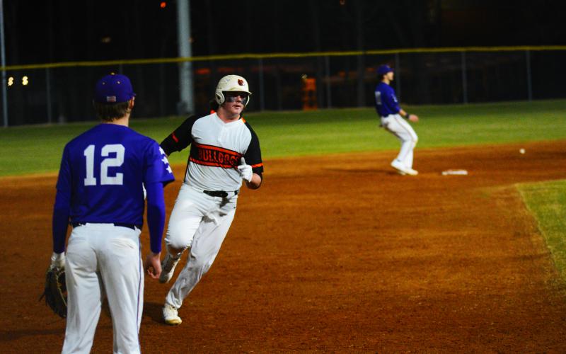Drew Dotson/ The Hartwell Sun - Peyton Powell rounds third against Athens Christian on Feb. 15.
