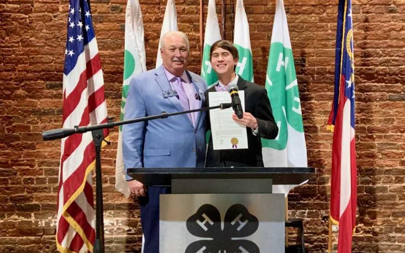 Senator Lee Anderson presenting Ben Tellano with the Senate proclamation.