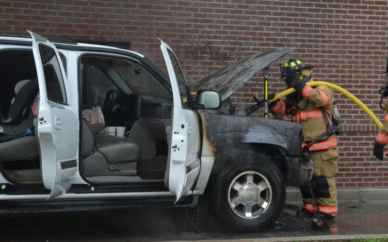 A Hartwell firefighter puts out the flames at Popeyes on Tuesday.