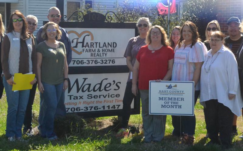 Pictured left, realtors and other Hartland employees join Chamber reps in front of the Hartland Realty office.