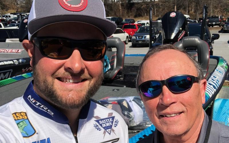 Local fisherman and Bassmaster Classic marshal David McGinnis, right, with his new friend and rising star angler Joey Nania.