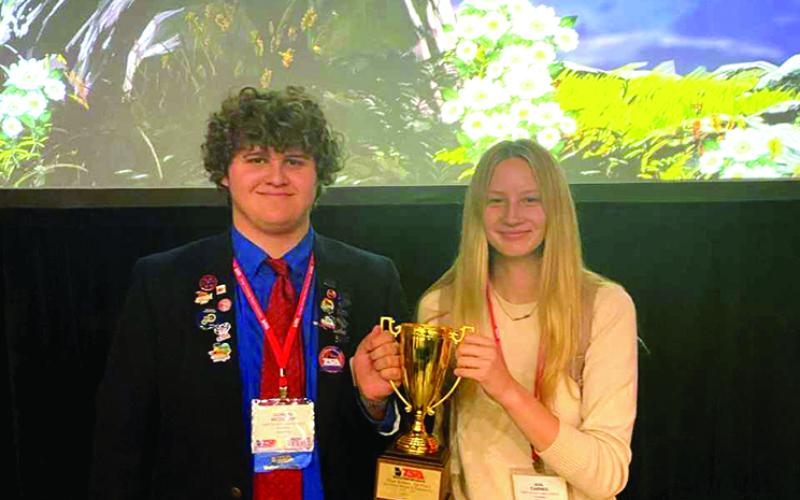 First place state title winners Ava Carnes and Duncan McDuffie show off their hardware.