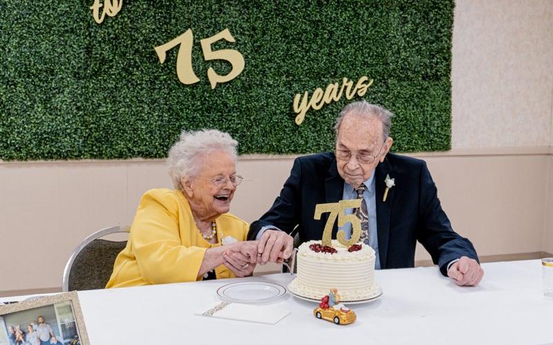 Jean and Albert Maxwell cut the cake together on Saturday in celebration of their 75th anniversary.