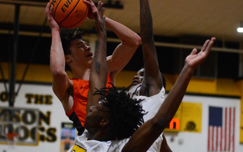 Johnny Curry takes a shot in traffic in his final high school game at Thomson High School on Saturday, Feb. 25.