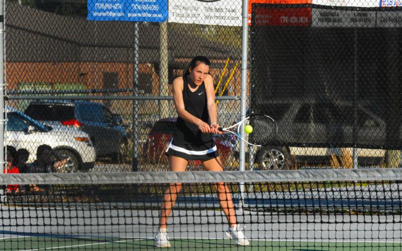 Ryleigh Jordan hits the backhand in her and Hannah Harris’s doubles win.