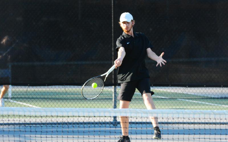 Daniel Leard returns serve against East Jackson on March 3.