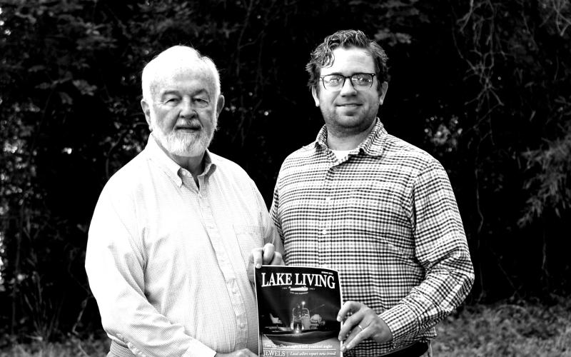 Award-winning photographer Bill Powell, left, stands alongside The Hartwell Sun publisher Dan Hunt and a print of his Lake Living cover shot.
