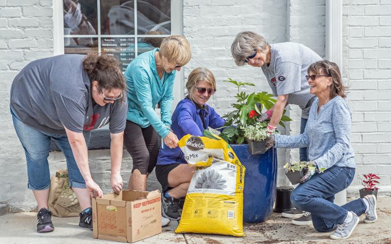 Main Street volunteers (L-R) Amanda Brown, Karen Vahaly, Chrissy Warren, Sandra Baker and Carol Beazley freshen up Depot Street.