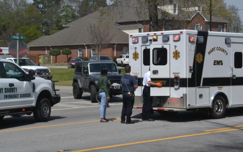 Hartwell EMS checks on a pedestrian in the back of ambulance who was allegedly struck by a car minutes earlier on Tuesday afternoon, April 12.