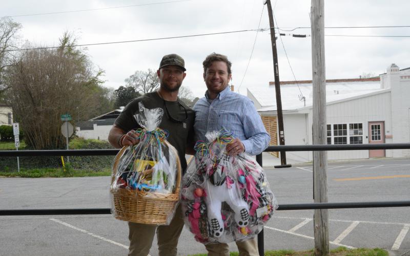 Paul Mitchell, left, displays his Golden Egg Hunt prize winnings alongside The Hartwell Sun publisher/editor Dan Hunt.