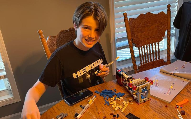 Jackson Ford lays out the pieces of his Titanic model in the initial phase.