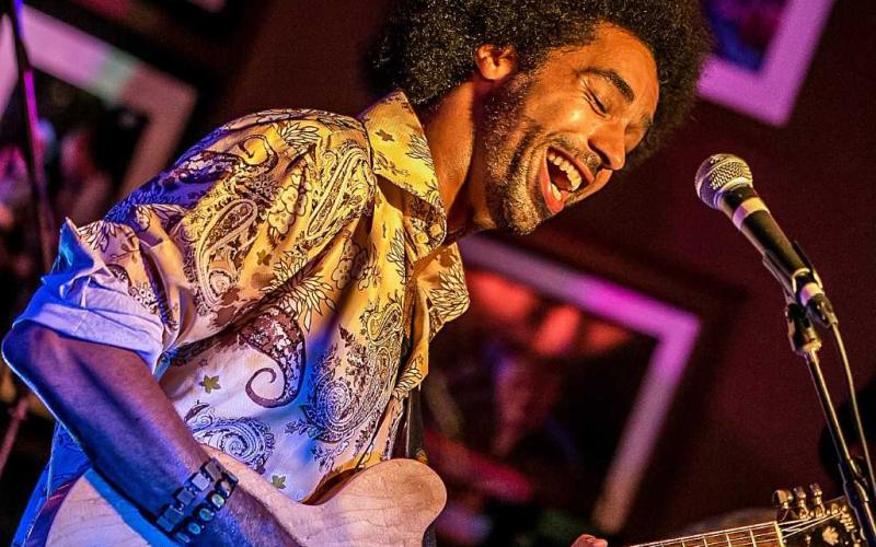 Selwyn Birchwood playing guitar during a set.