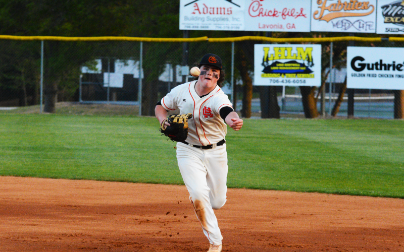 Drew Dotson/ The Hartwell Sun - Peyton Powell tosses the ball to first to get the second-to-last out against Stephens.