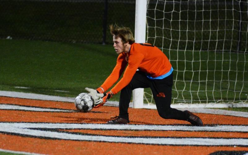 Tim Smart scoops up the ball against Madison County in the last home game of the season.