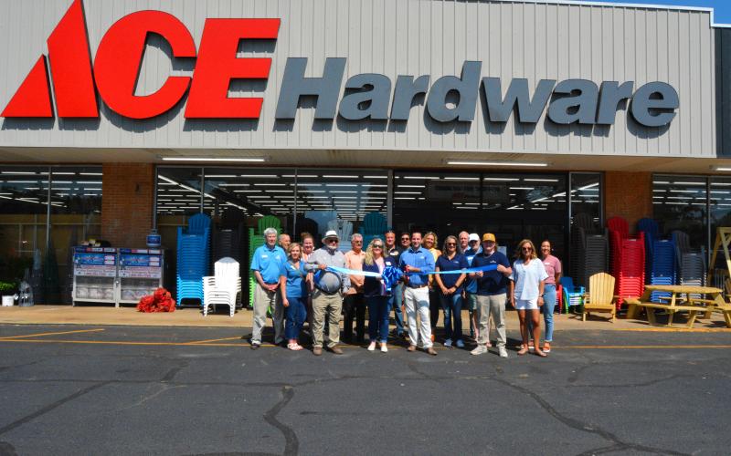 Community members meet for a ribbon cutting at Ace.