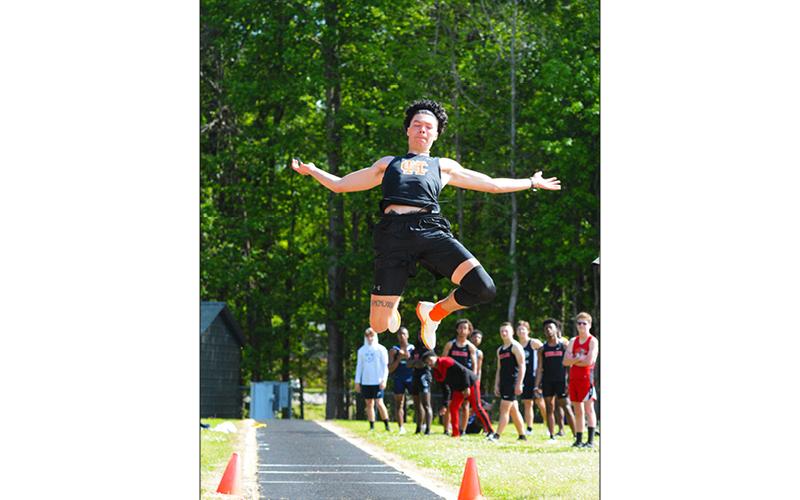 Johnny Curry flies through the air during the long jump at a home meet in Hart County earlier this season. Curry qualified for state championships in long jump, high jump and triple jump.