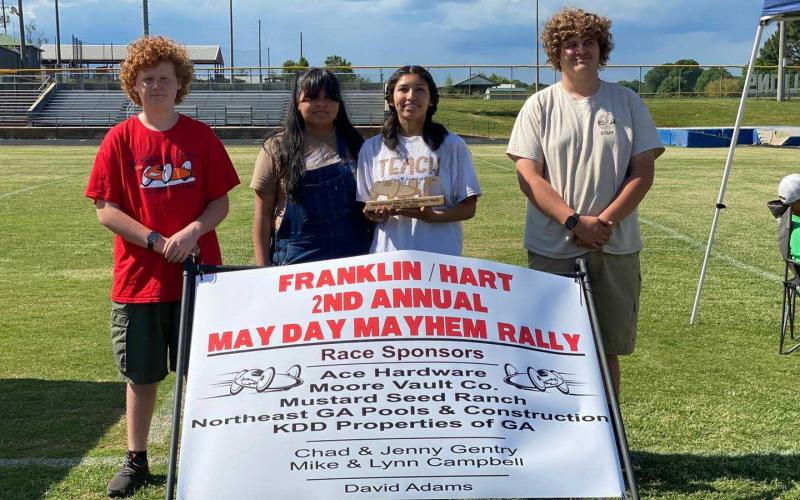Pictured are crew members Brody McDuffie, Aimee Aguilar, Gelsey Aguilar (driver), and Duncan McDuffie (crew chief).