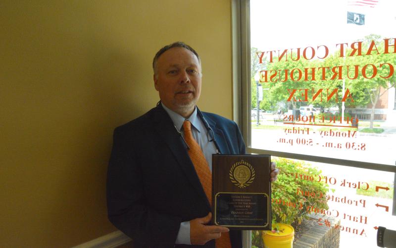 Hart County Clerk of Court Frankie Gray stands proudly with his award inside his office.