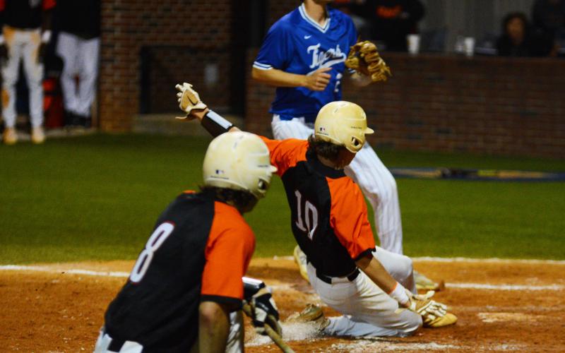 Zach Dombrowsky slides into home safe.