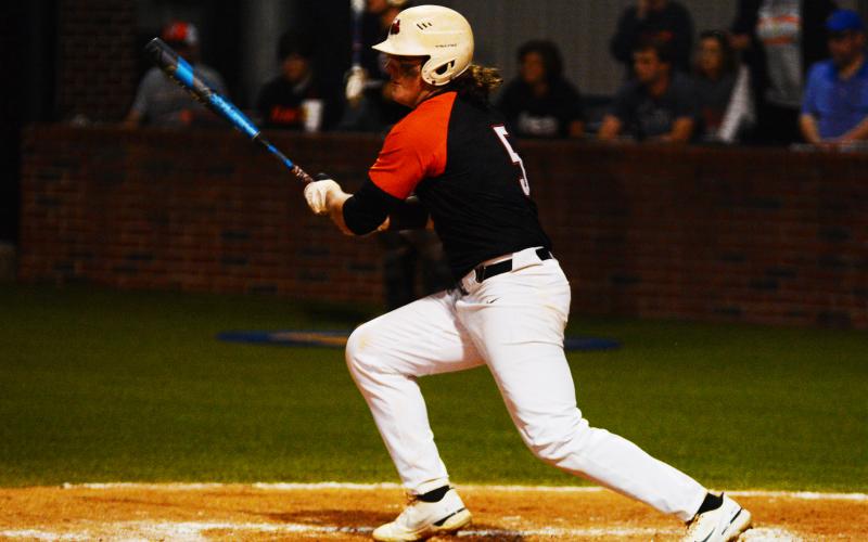 Peyton Powell prepares to run to first base after making contact.