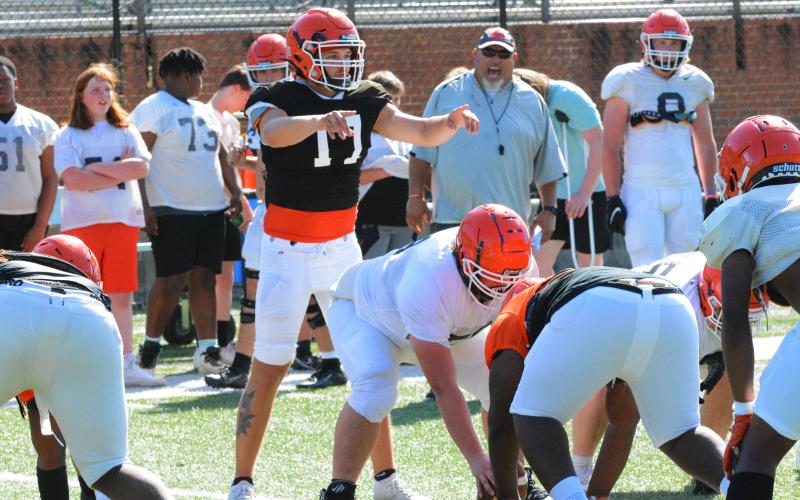 Senior quarterback Austen Whitworth directs the offense during a run drill at practice on May 12.