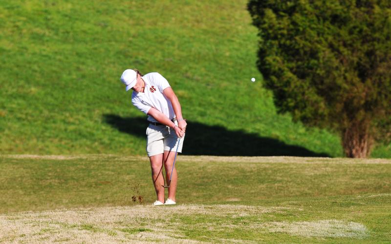 Kip Phillips takes a chip shot in a match against Oconee County earlier this season.