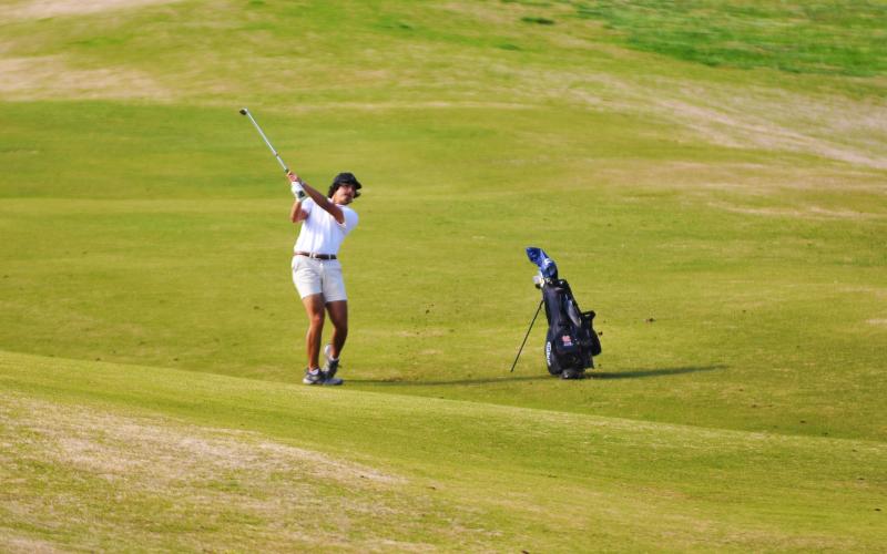 Payne Oglesby drives the ball on the rolling hills of Cateechee Golf Course.