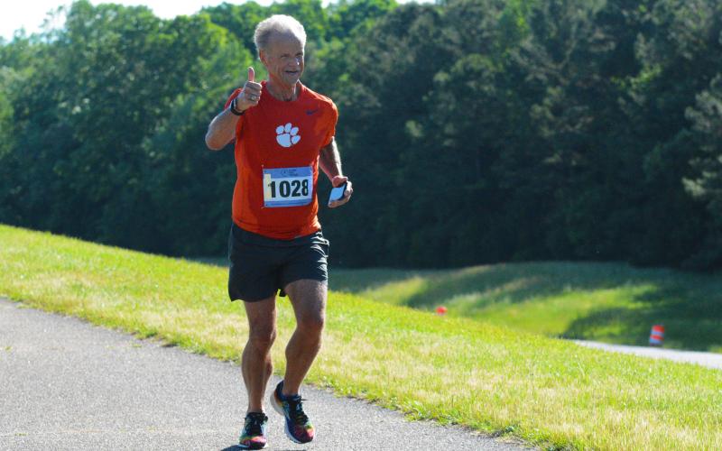Charles Cooper of Anderson, S.C., gives a thumbs-up as he approaches the finish line of the 10K run. T