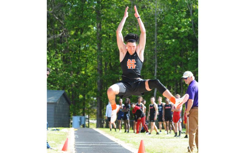 Johnny Curry long jumps in a home meet earlier this season. Curry won the state championship in the long jump and triple jump and placed second in the high jump.