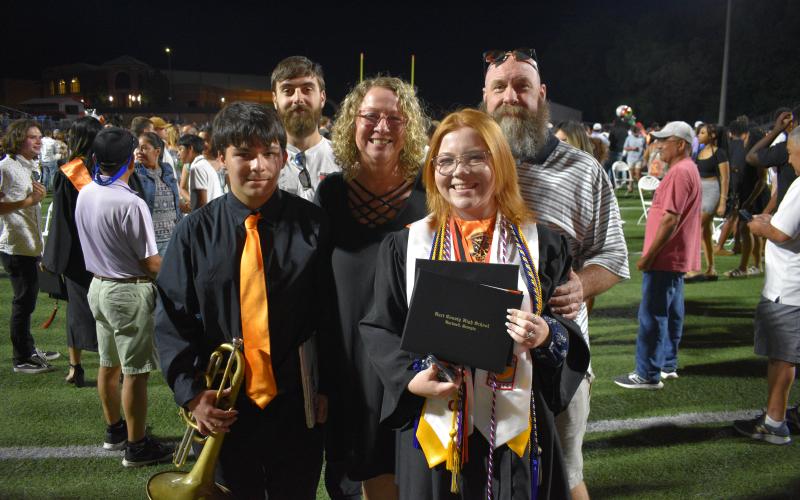 Anna Richardson (front) smiles big with her family after the graduation ceremony. Richardson will be attending Furman University this fall.