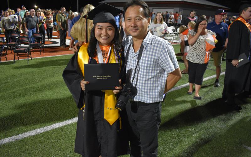 rene Mai and her father Nghi Mai are all smiles at the close of the ceremony.