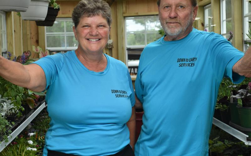 Sheryl Antrim (left) and Wes Antrim stand in the door of their mobile greenhouse at the Pre-Fouth Festival.