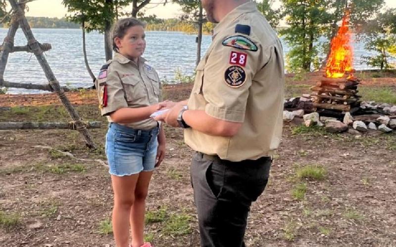 Evie McCurley, with her dad Josh McCurley, at the Scouts’ graduation ceremony.