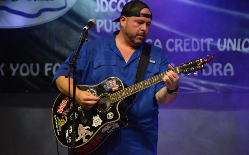 Drew Dotson/The Hartwell Sun - Guitarist Adrian Lee performs with his band 3 and Twenty during the Lake Hartwell Music Festival.