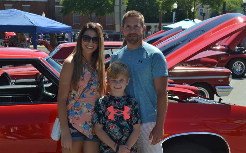 Dan Hunt/The Hartwell Sun - Michael and Marianna Steele and their son Landon pose with a classic car on the square during this past weekend’s Cars &amp; Guitars Festival.