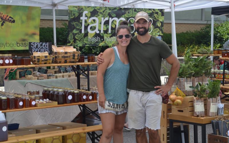 Matt Morales (right) and Abby Morales (left) were hard at work selling products from their business, Farm 328.