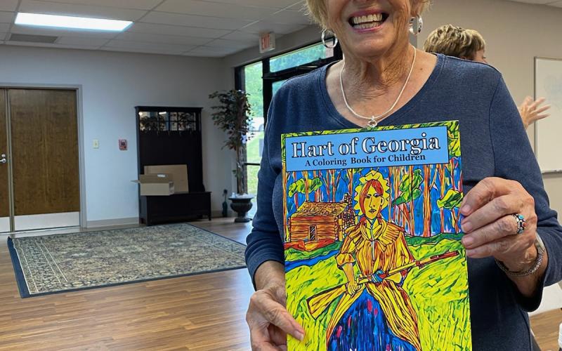 Kay Cleveland shows off her coloring book, which serves as a map of historical places in Hartwell.