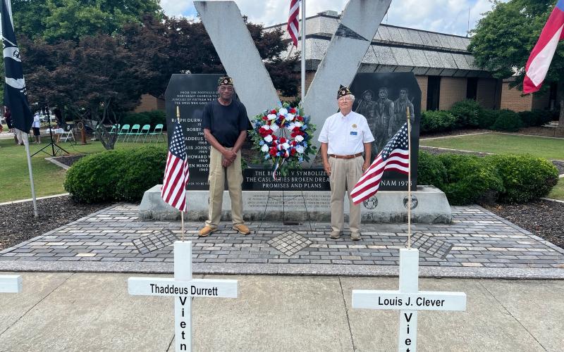 Josh Brannen/The Hartwell Sun - Vietnam veterans Thomas Morrison, left, and Bruce Jones, right, place the Memorial Day wreath at Veterans Memorial Park to honor Hart County men who sacrificed themselves in combat.