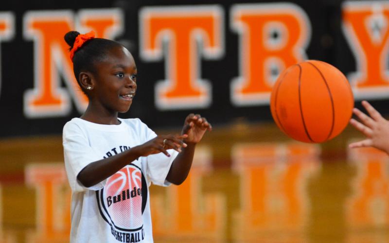 Brooklyn McIntosh checks the ball in a friendly one-on-one at last year’s basketball camp.