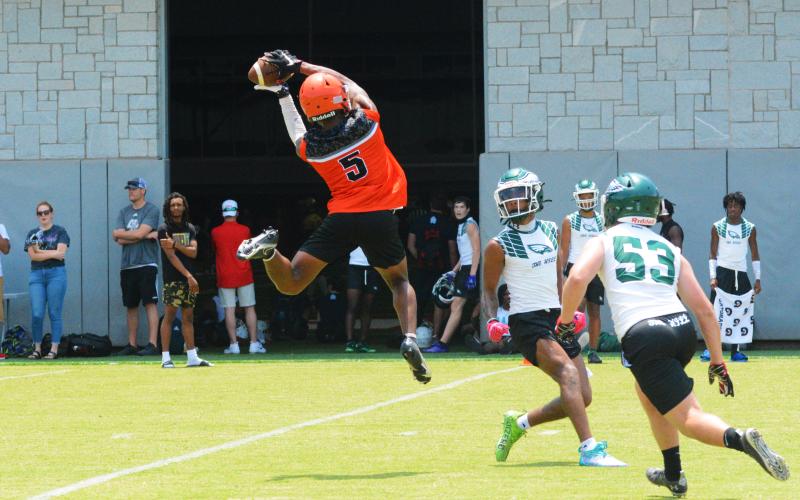 Jashon Gaines snags a pass over the head of Collins Hill defenders.