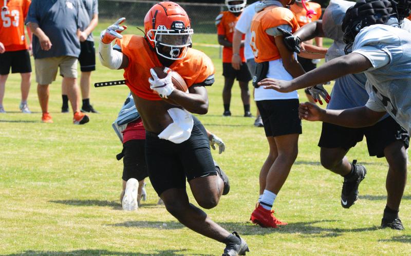 Running back Nori Moore makes a cut away from a Morgan County defender