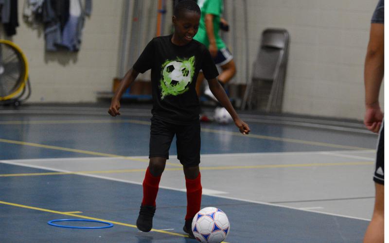 Kingston Durham practices his ball handling skills in the YMCA gym.