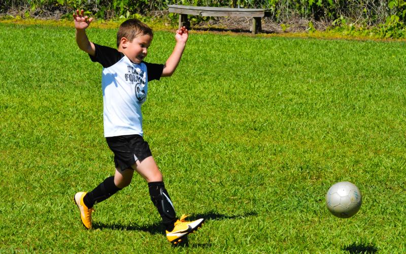 Wade Trent chases the ball at the YMCA soccer camp last year.