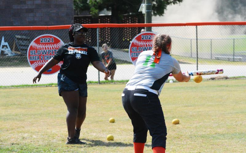 Endiya Burton tosses the ball to Peyton Woodall for bunting practice on Monday, June 20.
